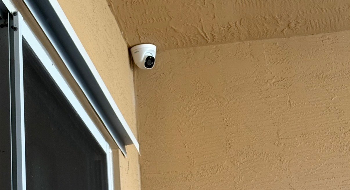 One commercial CCTV security camera monitoring the exterior of a business building.