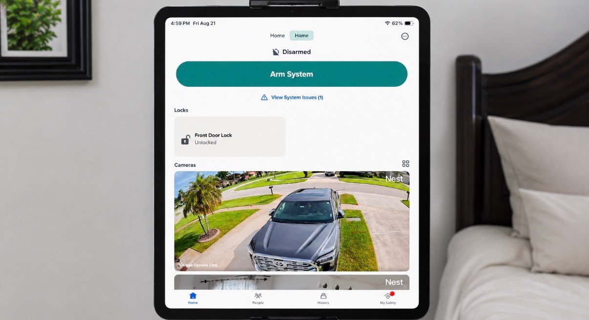 iPad displaying a smart home app for controlling security cameras, alarm system, smart locks, lighting, and home automation devices.