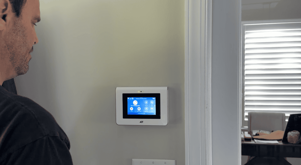 A CSS technician updating the Wi-Fi password on an ADT Command panel in Wellington, Florida